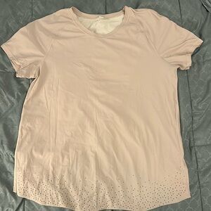 Light mauve lululemon short sleeve running tee with detailed back. Size 6